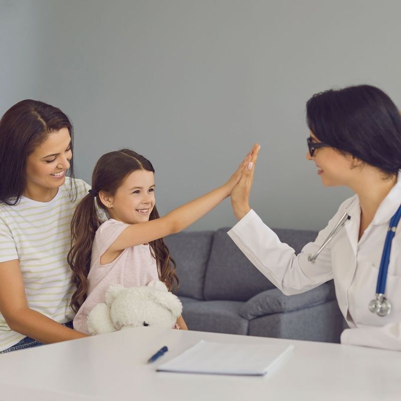 mom and daughter talking to a pediatrician